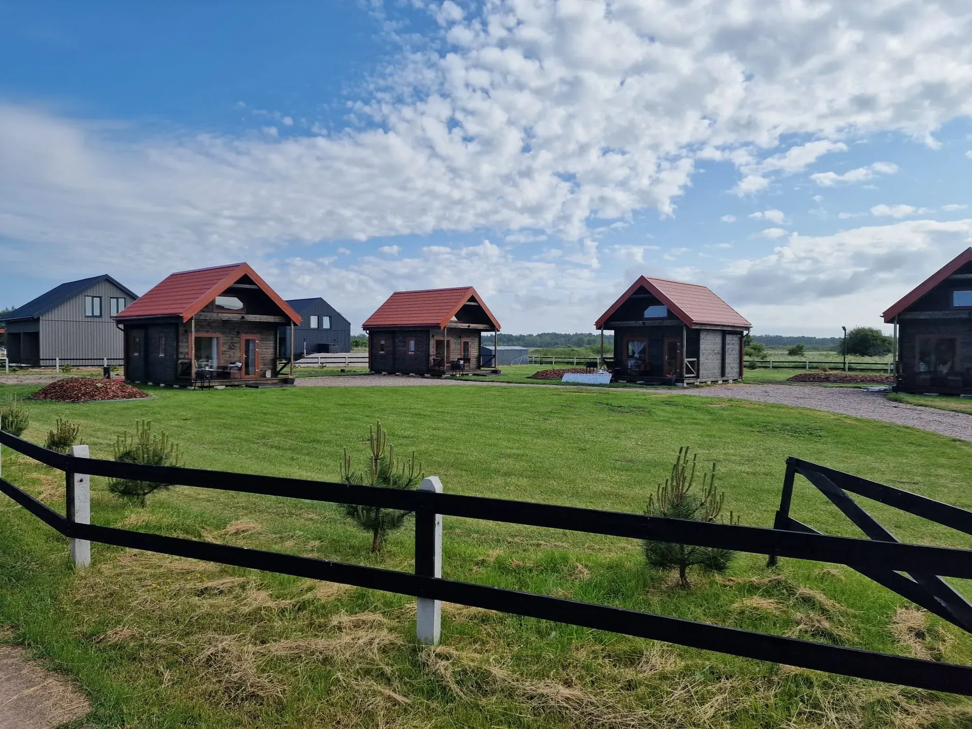 Several Satus Baltic log cabins with terraces on one site