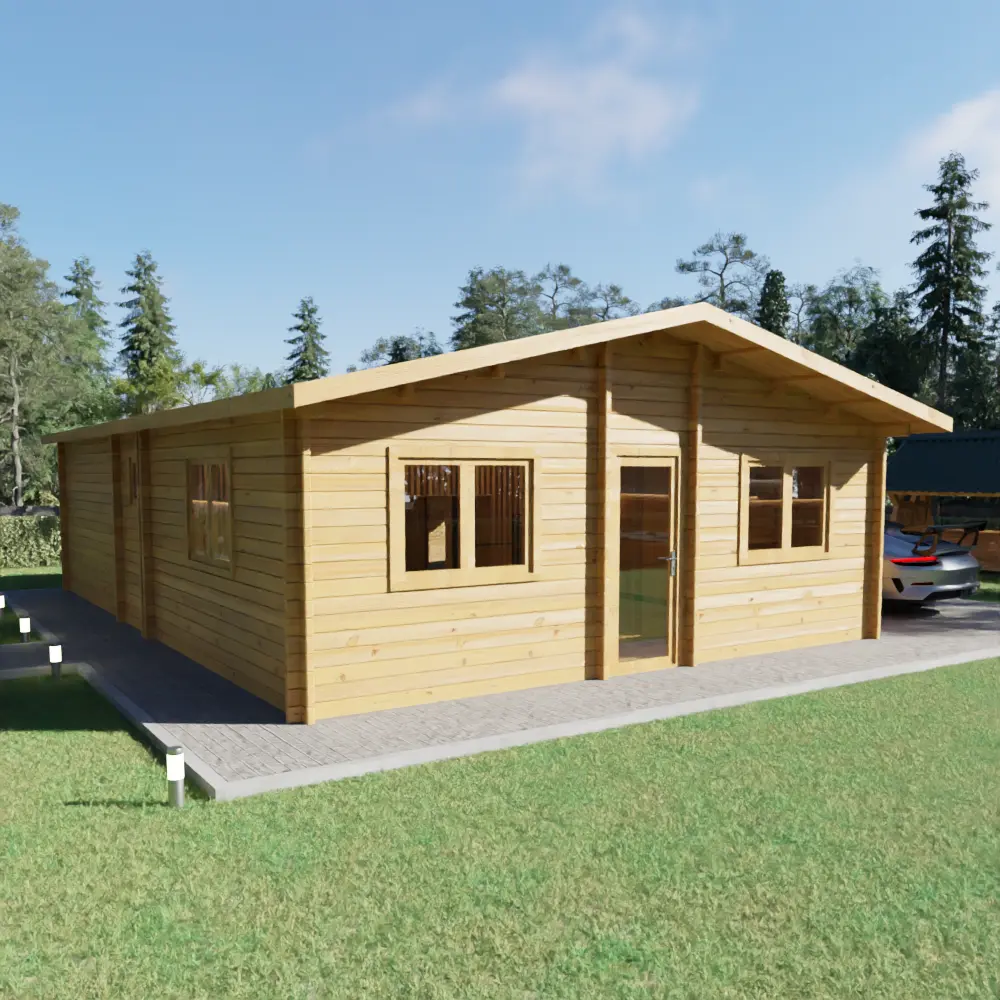 Single-story wooden cabin with a gabled roof, multiple windows, and a glass door, set on a paved area surrounded by grass and trees.
